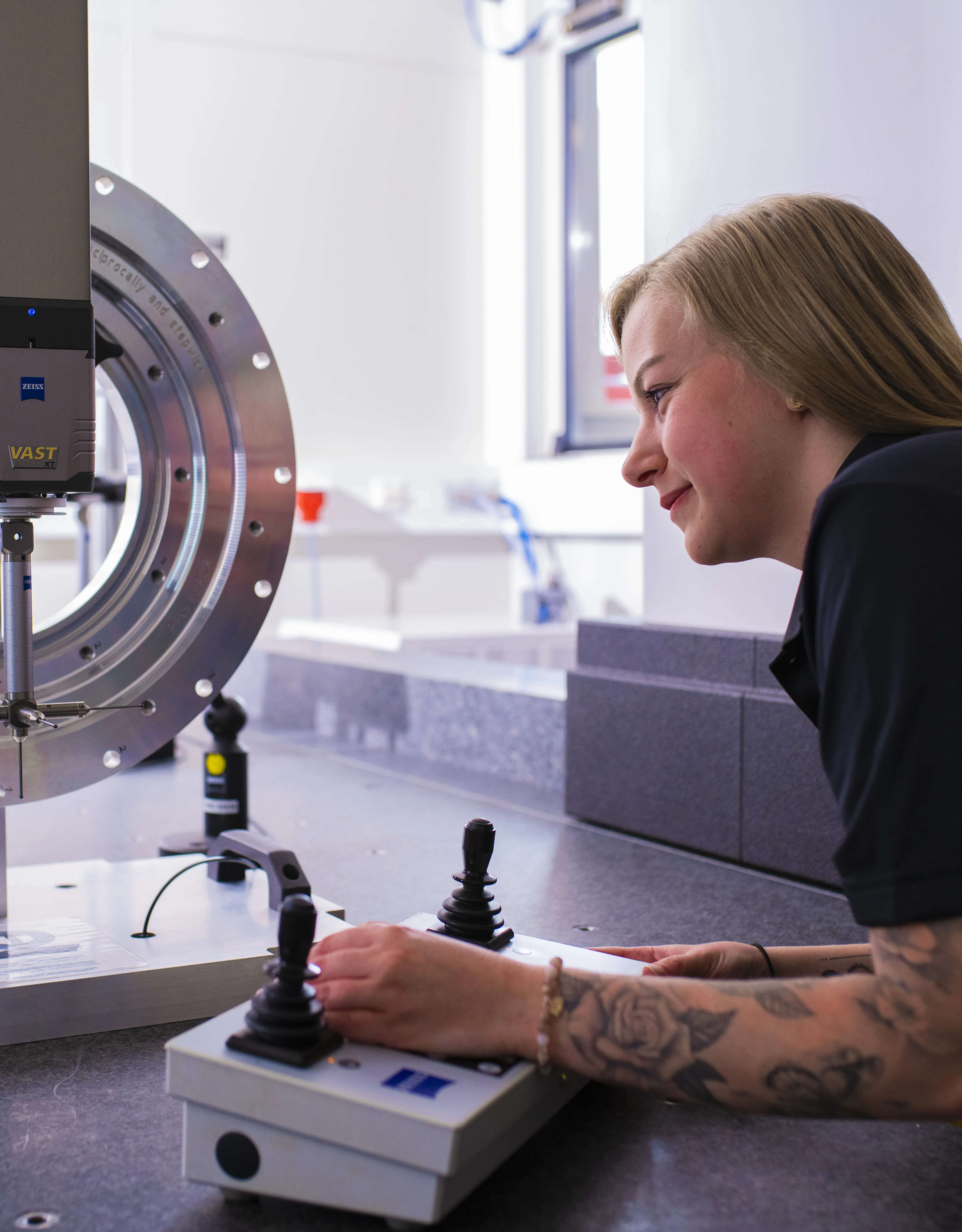 Employee at a machine with steering devices